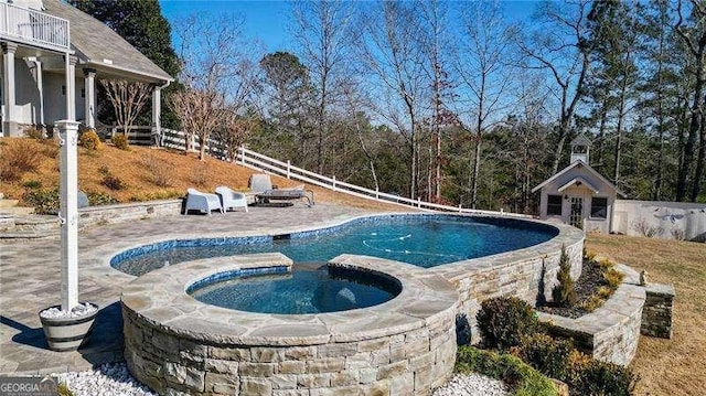 view of pool with a fenced in pool, a patio area, fence, and an in ground hot tub