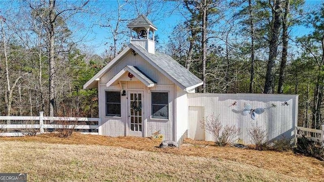 view of outdoor structure with an outbuilding and fence