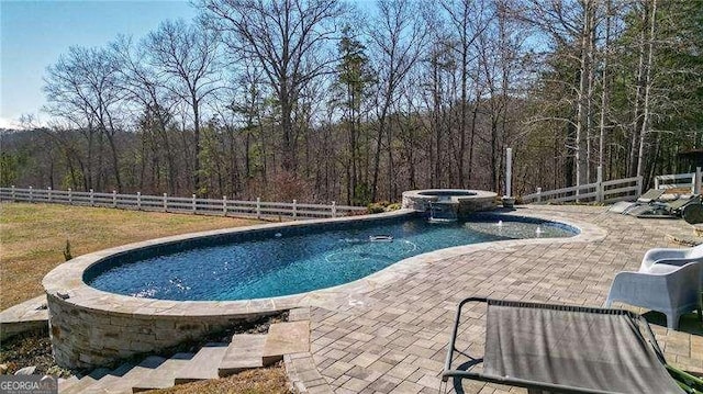 view of swimming pool featuring a fenced in pool, a patio area, fence, and an in ground hot tub