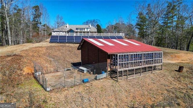 view of outbuilding with an outdoor structure and solar panels