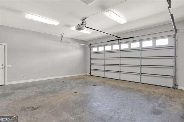 garage with a garage door opener and baseboards