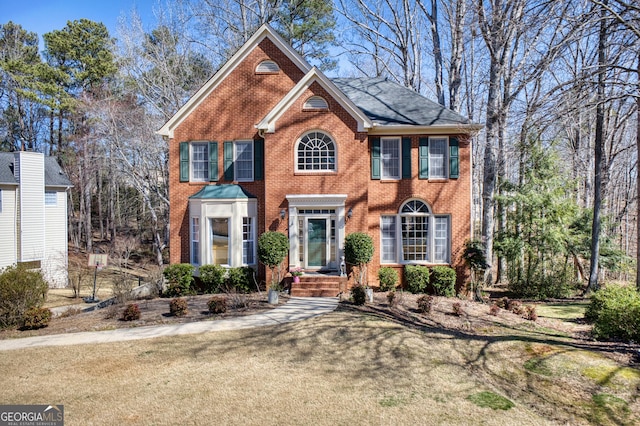 colonial home with brick siding