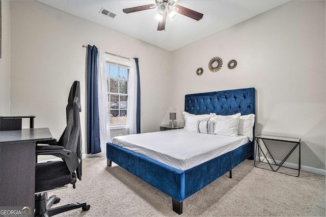 carpeted bedroom featuring a ceiling fan, visible vents, and baseboards