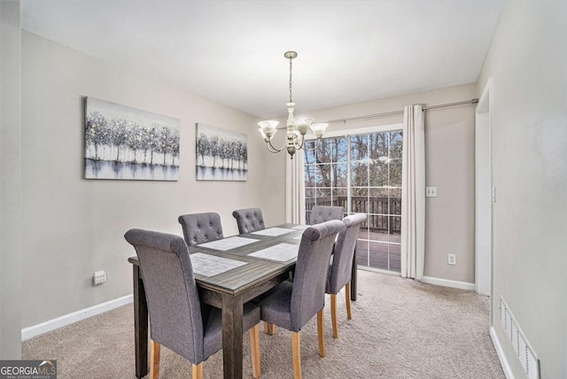 dining area featuring light colored carpet, visible vents, baseboards, and an inviting chandelier