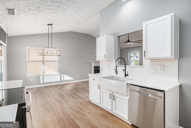 kitchen with visible vents, ceiling fan, lofted ceiling, stainless steel dishwasher, and a sink