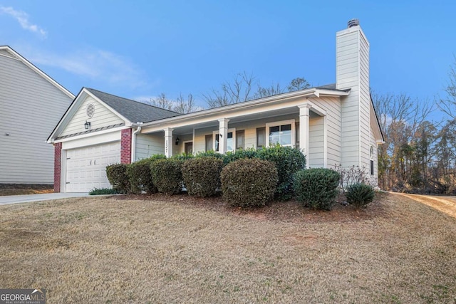 ranch-style house featuring a garage, brick siding, concrete driveway, and a chimney