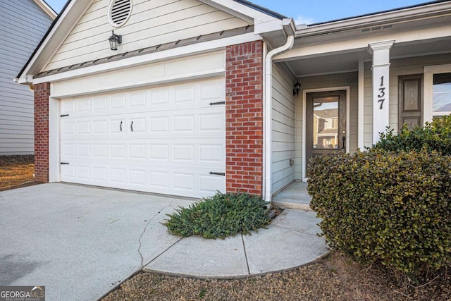 exterior space with brick siding, driveway, and an attached garage