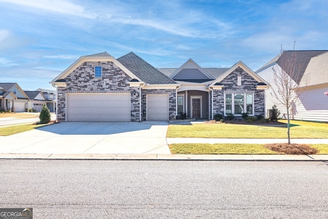 view of front of home with a garage, concrete driveway, a front yard, and roof with shingles