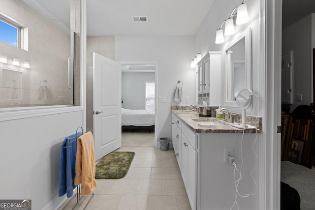 ensuite bathroom with a tile shower, visible vents, ensuite bath, and a sink