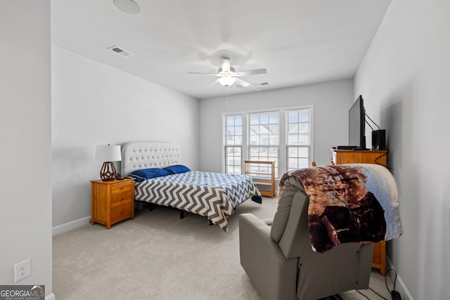 bedroom with light carpet, visible vents, a ceiling fan, and baseboards