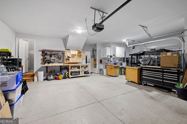 garage with a workshop area and a garage door opener