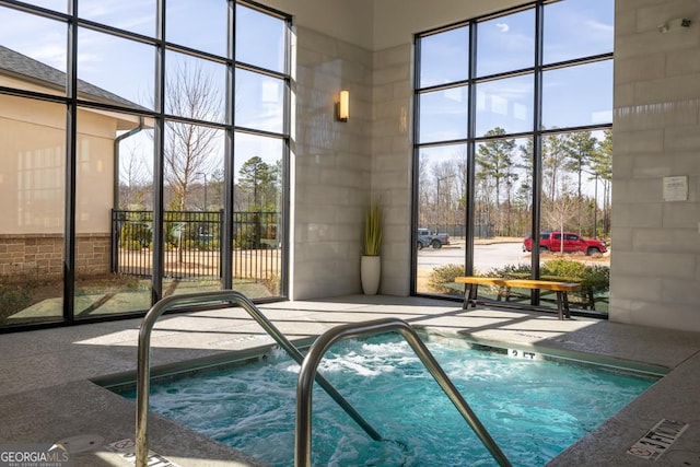 view of swimming pool featuring an indoor hot tub