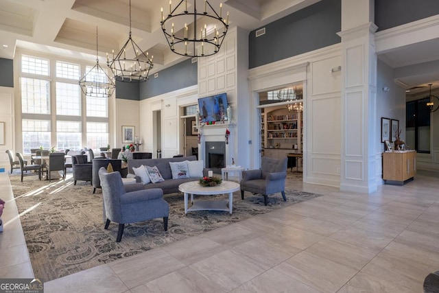 living room with a decorative wall, built in shelves, a high ceiling, and coffered ceiling