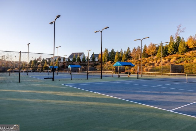 view of tennis court featuring fence