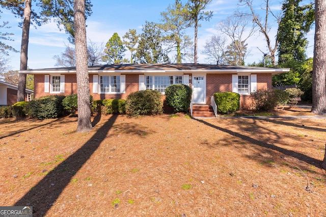 single story home with entry steps and brick siding