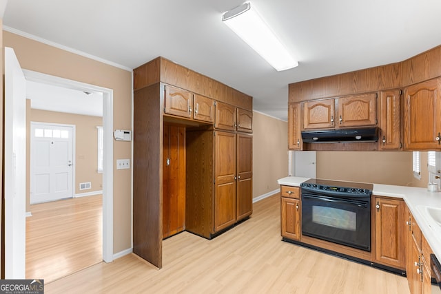 kitchen with light wood-style flooring, electric range, light countertops, and under cabinet range hood