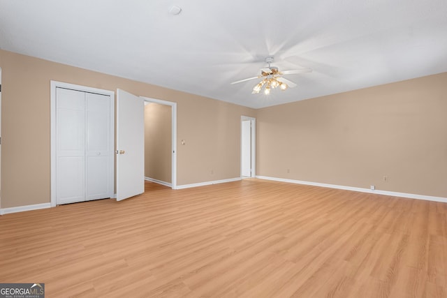 interior space with light wood finished floors, ceiling fan, and baseboards