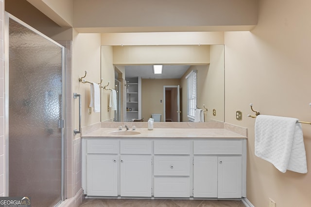 full bathroom with a shower stall and vanity