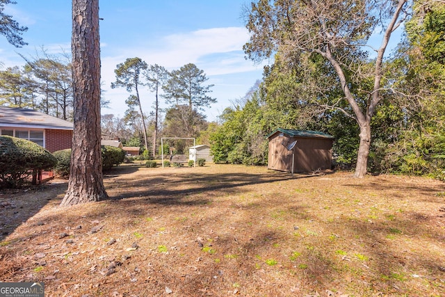 view of yard featuring an outbuilding and a shed