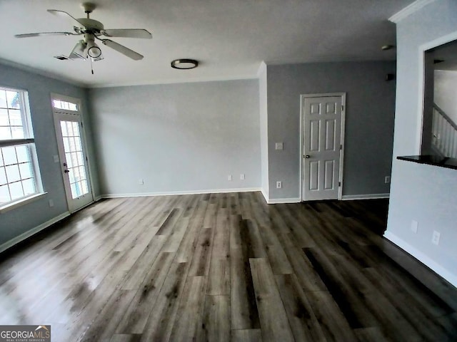 interior space with ceiling fan, dark wood-style flooring, visible vents, and baseboards