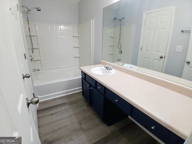 bathroom with shower / bathing tub combination, wood finished floors, and vanity