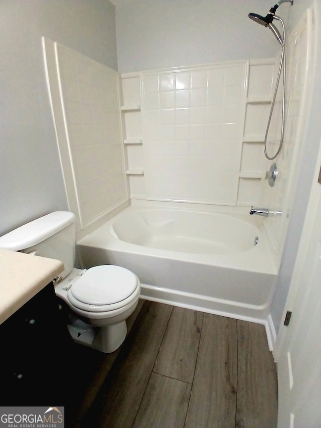 full bathroom featuring tub / shower combination, vanity, toilet, and wood finished floors