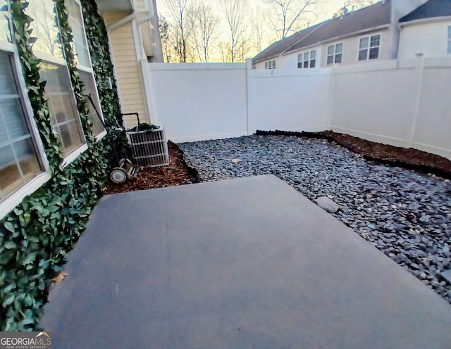 view of patio with cooling unit and fence