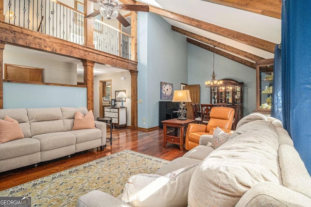 487 Glendale Ct, Stone Mountain, GA 30087 - living room with high vaulted ceiling, ceiling fan with notable chandelier, wood finished floors, beamed ceiling, and decorative columns