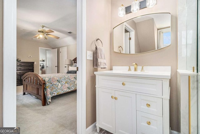 487 Glendale Ct, Stone Mountain, GA 30087 - ensuite bathroom with visible vents, connected bathroom, ceiling fan, vaulted ceiling, and vanity