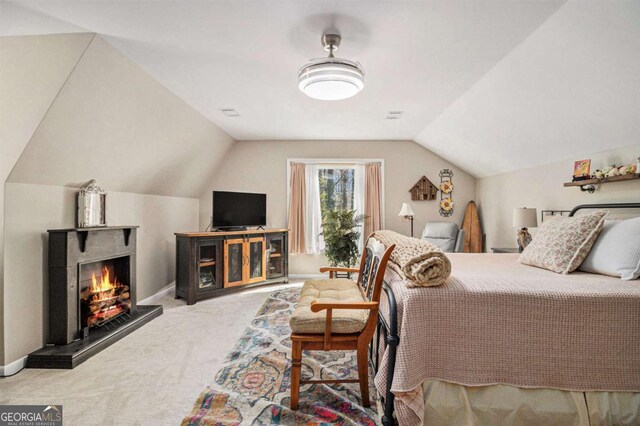 487 Glendale Ct, Stone Mountain, GA 30087 - carpeted bedroom with a warm lit fireplace, vaulted ceiling, and baseboards