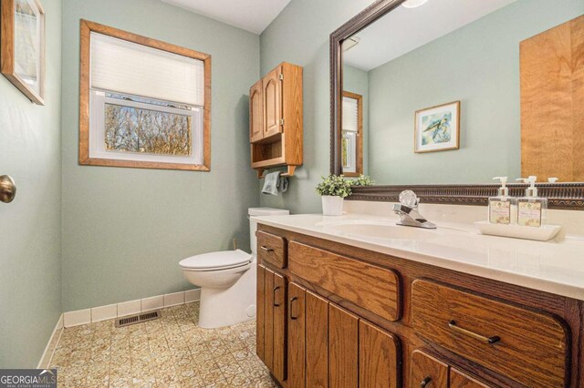 487 Glendale Ct, Stone Mountain, GA 30087 - bathroom featuring visible vents, baseboards, vanity, and toilet