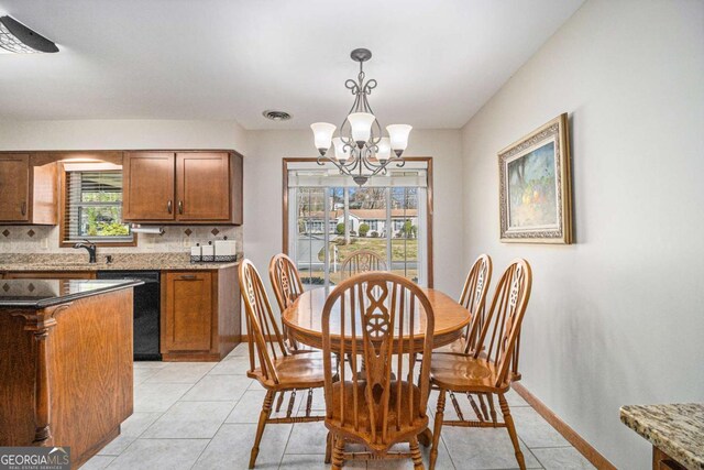 487 Glendale Ct, Stone Mountain, GA 30087 - dining room featuring light tile patterned flooring, visible vents, baseboards, and an inviting chandelier