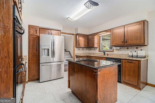 487 Glendale Ct, Stone Mountain, GA 30087 - kitchen with light tile patterned flooring, dark stone counters, stainless steel fridge with ice dispenser, decorative backsplash, and dishwasher