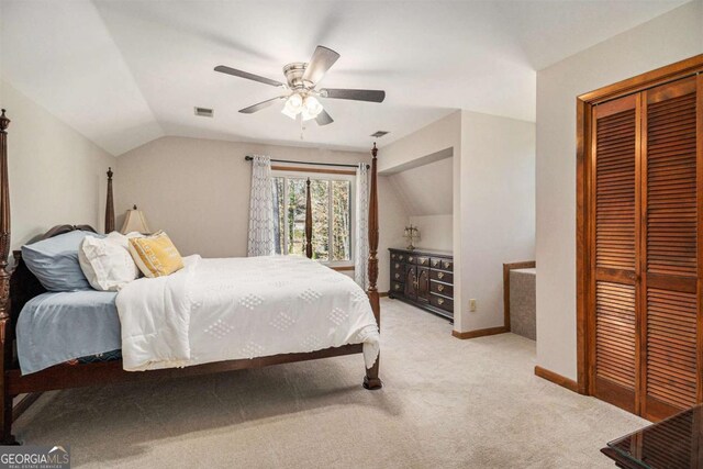 487 Glendale Ct, Stone Mountain, GA 30087 - bedroom with lofted ceiling, light colored carpet, a ceiling fan, baseboards, and a closet