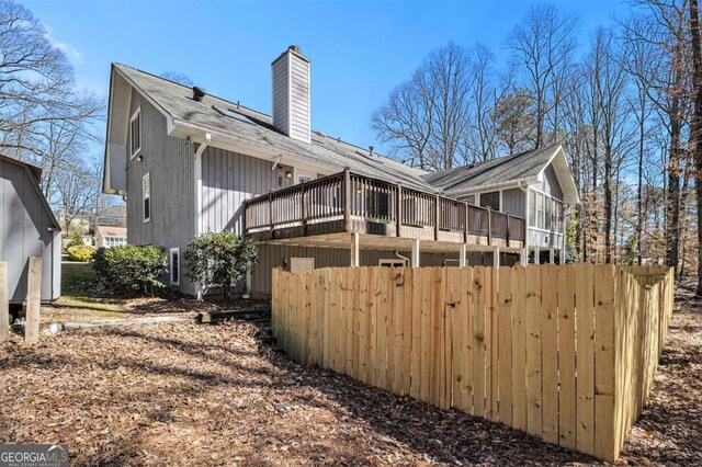487 Glendale Ct, Stone Mountain, GA 30087 - rear view of property with a deck and a chimney