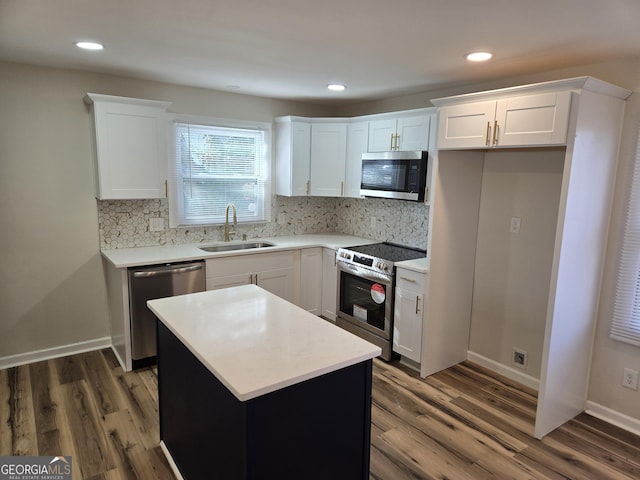 938 Rebel Forest Dr SE, Atlanta, GA 30315 - kitchen featuring stainless steel appliances, dark wood-type flooring, a sink, and white cabinetry