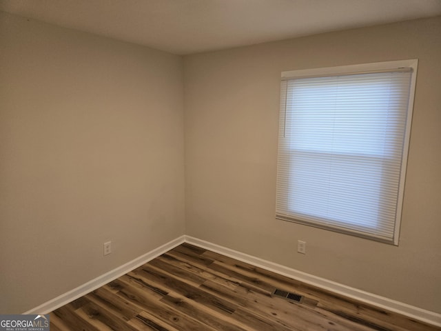 938 Rebel Forest Dr SE, Atlanta, GA 30315 - spare room featuring baseboards, visible vents, and dark wood finished floors
