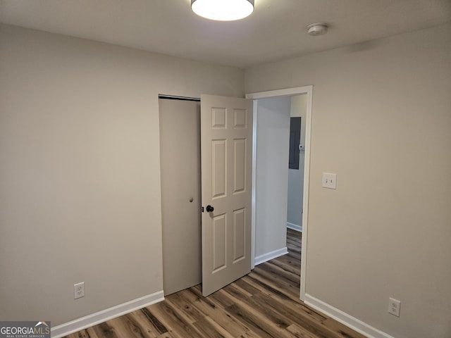 938 Rebel Forest Dr SE, Atlanta, GA 30315 - unfurnished bedroom with dark wood-style floors, baseboards, and a closet