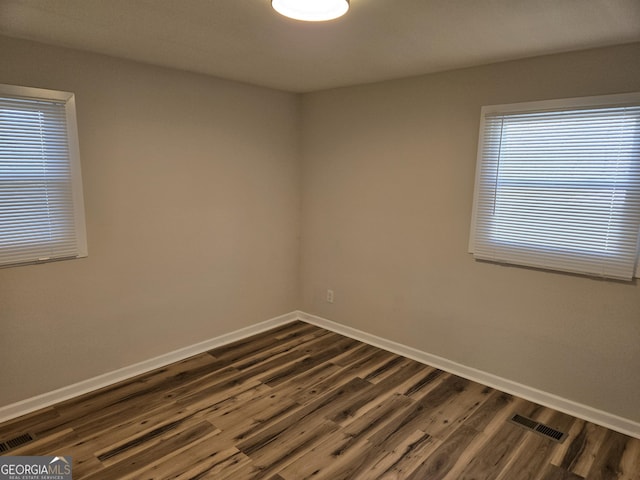 938 Rebel Forest Dr SE, Atlanta, GA 30315 - unfurnished room featuring dark wood-style flooring, visible vents, and baseboards