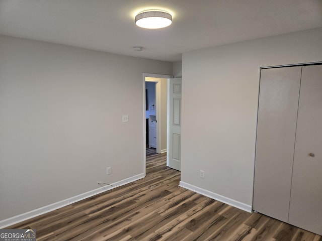 938 Rebel Forest Dr SE, Atlanta, GA 30315 - unfurnished bedroom with a closet, dark wood finished floors, and baseboards