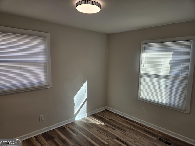 938 Rebel Forest Dr SE, Atlanta, GA 30315 - spare room featuring visible vents, dark wood finished floors, and baseboards