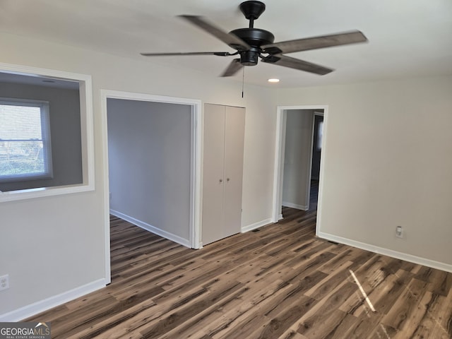 938 Rebel Forest Dr SE, Atlanta, GA 30315 - unfurnished bedroom featuring ceiling fan, baseboards, dark wood finished floors, and a closet