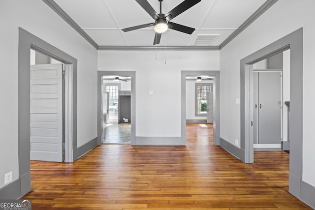 spare room featuring hardwood / wood-style flooring, coffered ceiling, visible vents, and baseboards