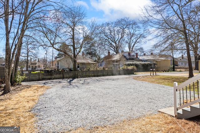 exterior space featuring a residential view and fence