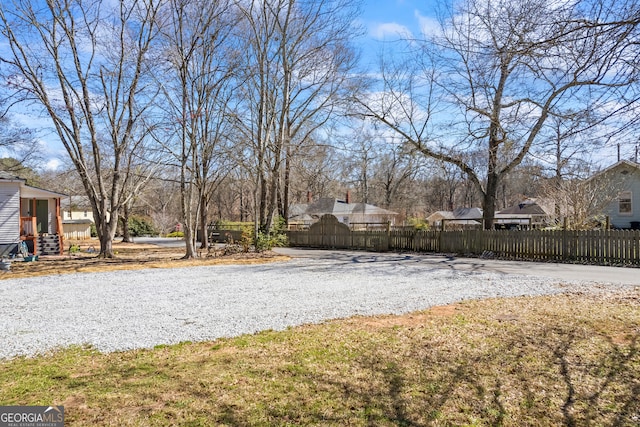view of yard featuring a fenced front yard and driveway