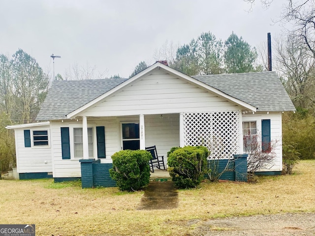 view of front of house with covered porch and roof with shingles