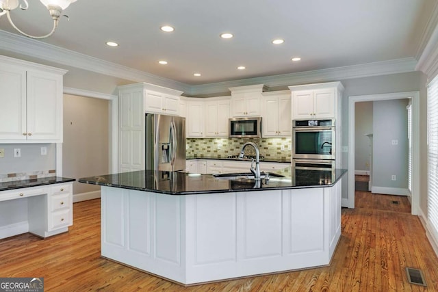 kitchen featuring a sink, visible vents, white cabinetry, appliances with stainless steel finishes, and light wood-type flooring