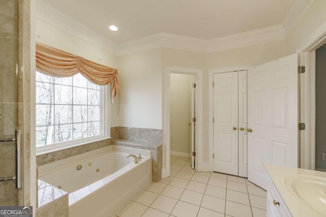 bathroom with a whirlpool tub, ornamental molding, vanity, and tile patterned floors