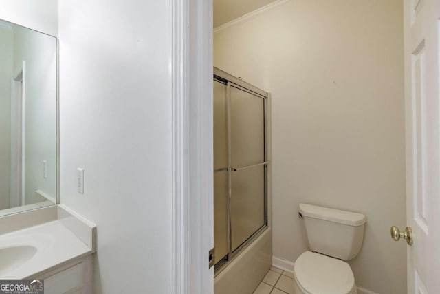 bathroom featuring bath / shower combo with glass door, toilet, ornamental molding, vanity, and tile patterned flooring