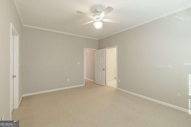 unfurnished bedroom with crown molding, light colored carpet, a ceiling fan, connected bathroom, and baseboards